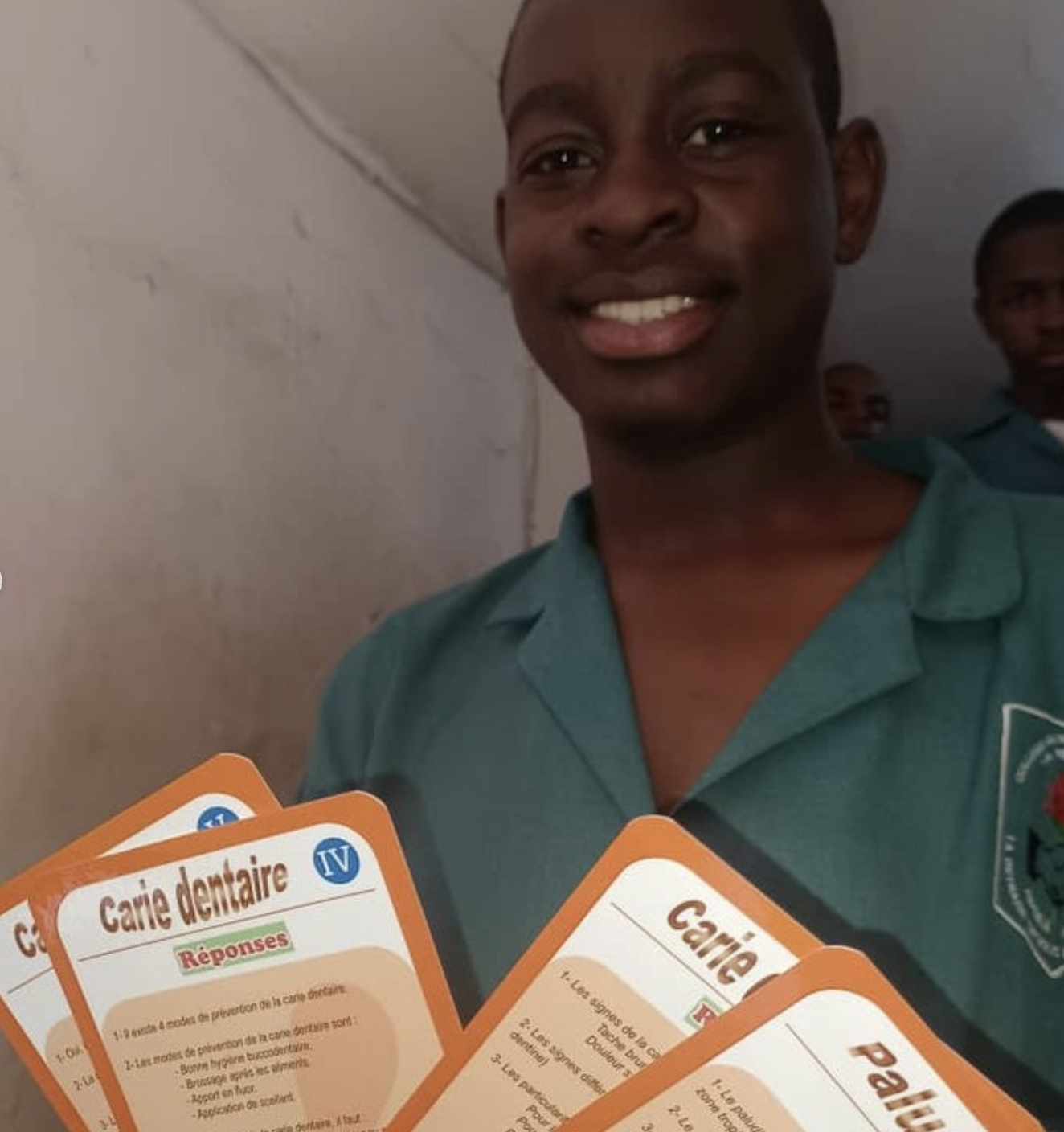 Élève en uniforme bleu avec cartes SIDA